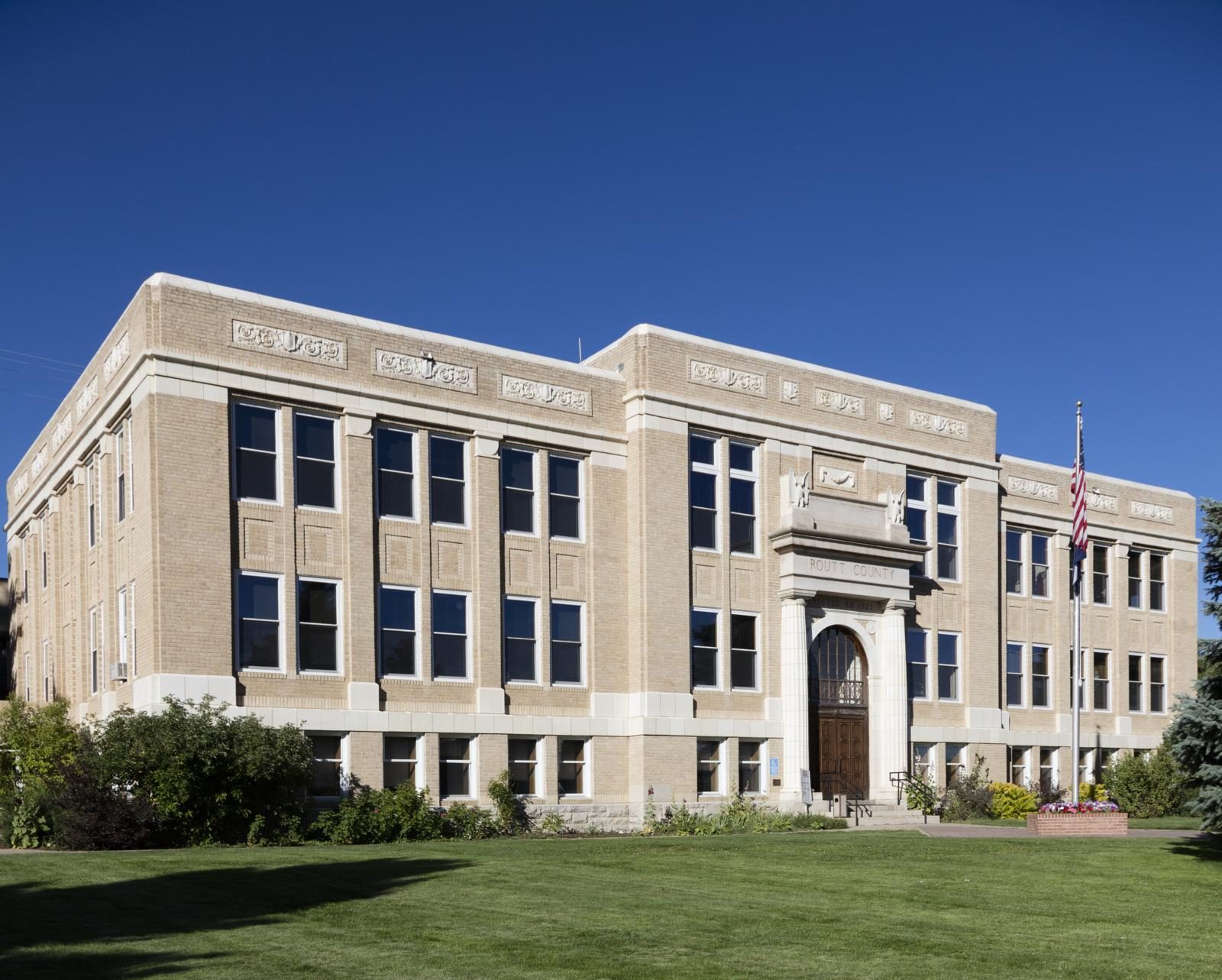 Brightwater City Hall with an American flag on a green lawn
