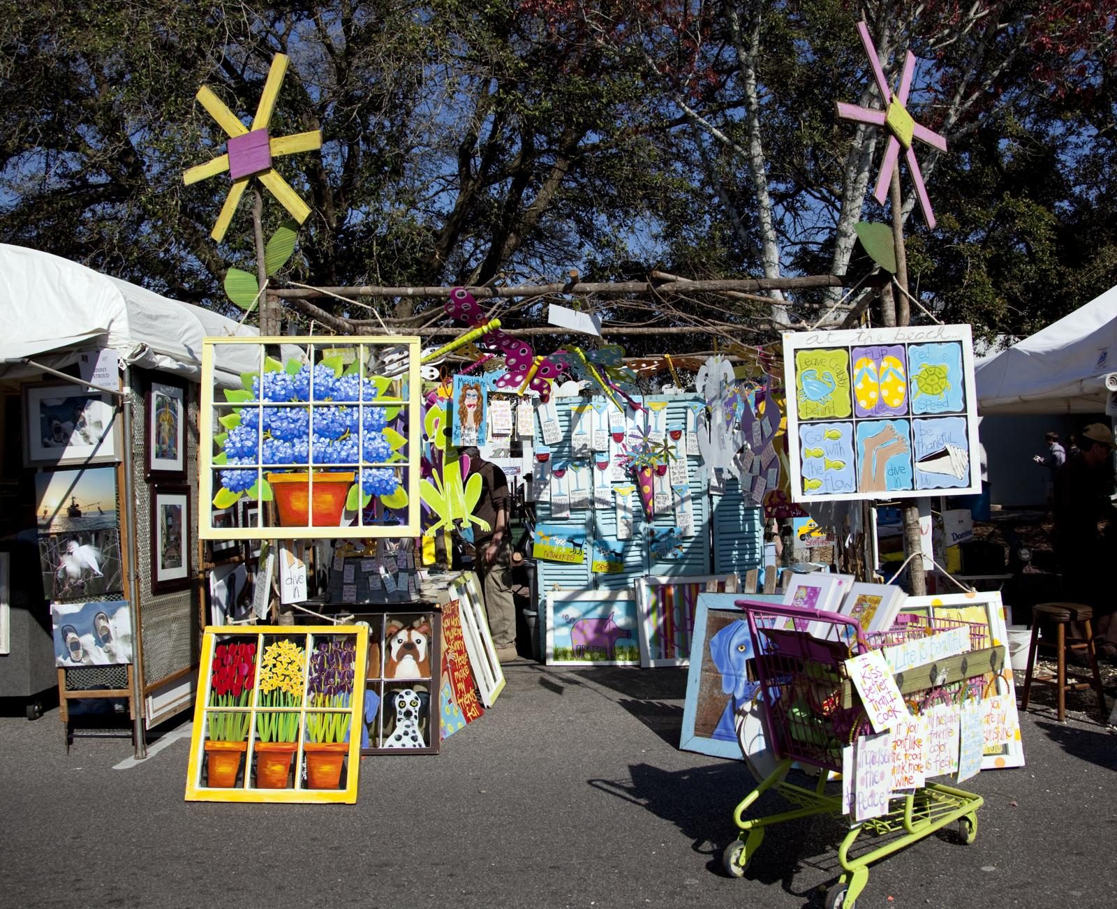 Colorful artwork on display in vendor booths at the Fall Festival and Art Walk