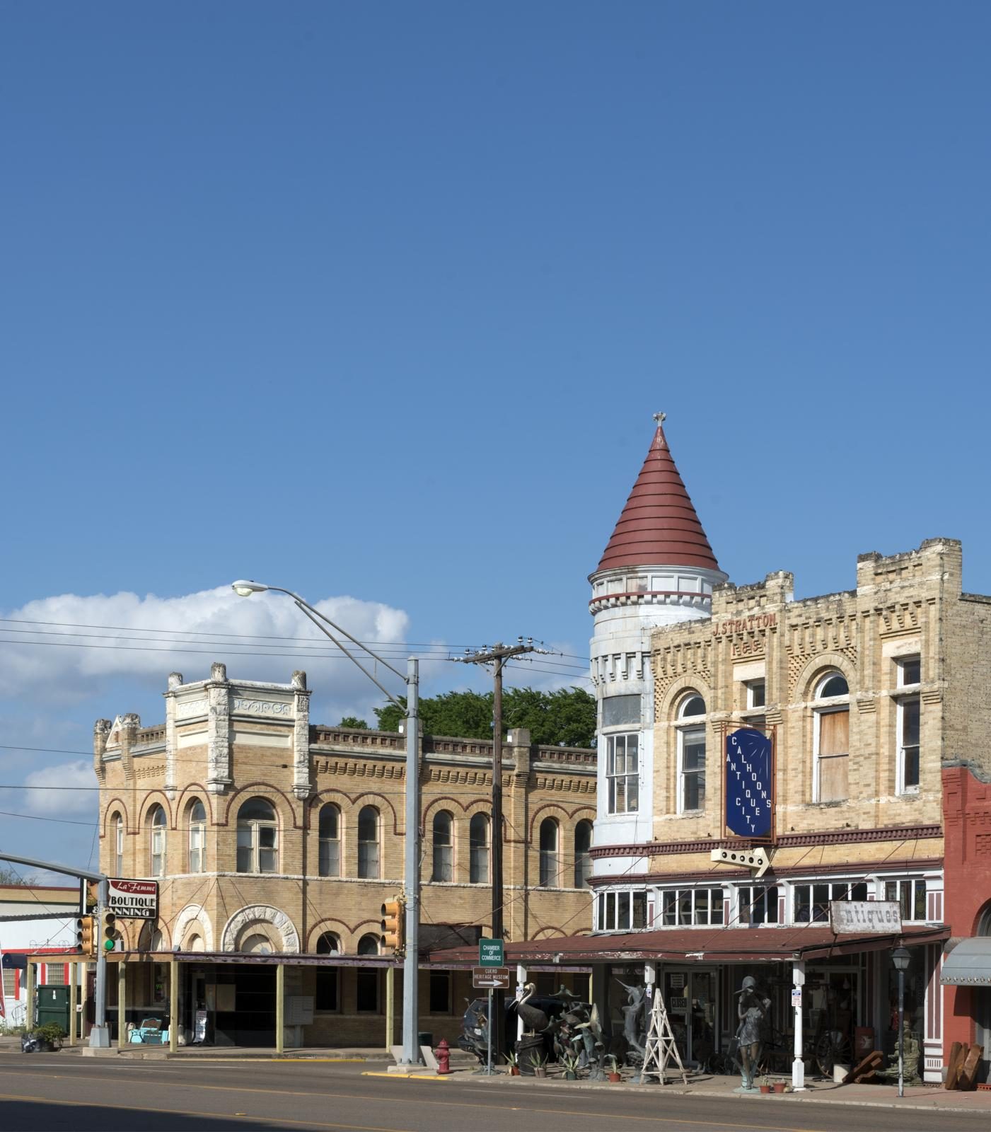 Historic brick storefronts with a corner turret on Main Street