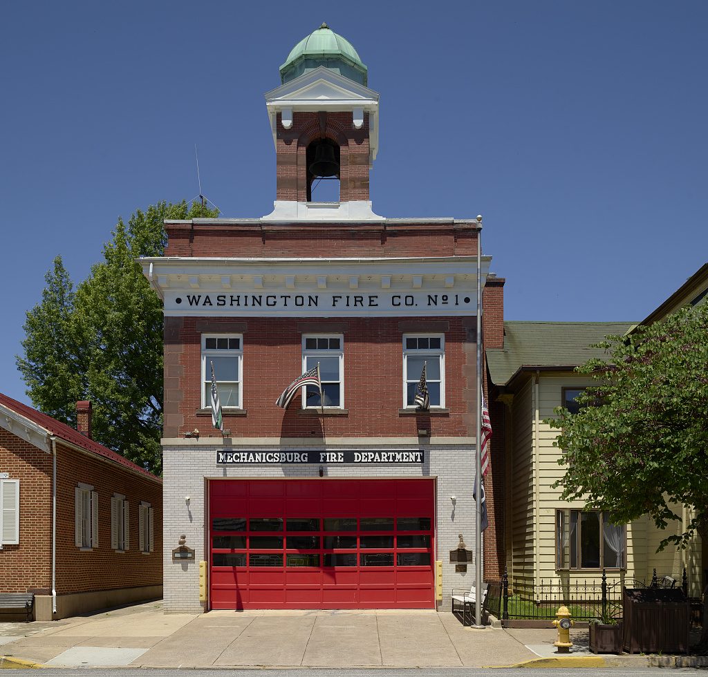 Fire Station No. 1, a brick firehouse with a bell tower and American flags